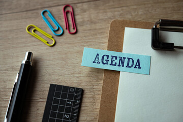 There is sticky note with the word Agenda. It is as an eye-catching image.