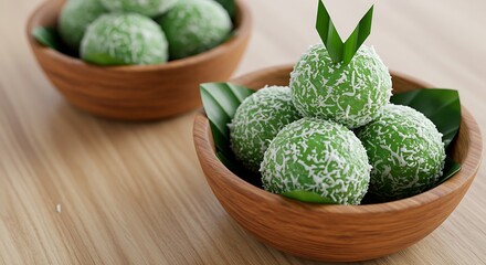 Green klepon cake serve on wooden bowl. This cake is indonesia traditional street food it usually serve as snack on the morning breakfast. 