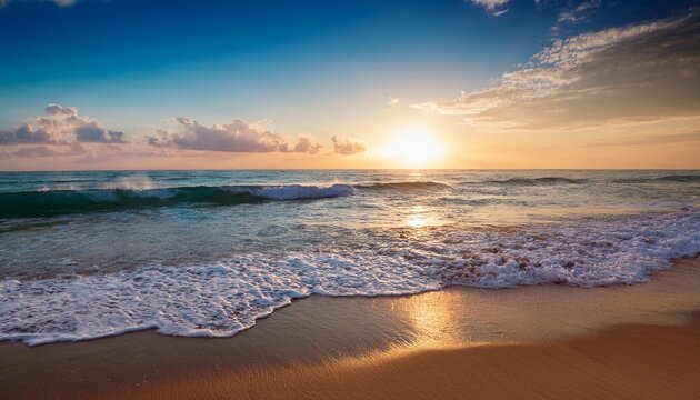 gentle ocean waves rolling onto a sandy beach under a clear sky with soft clouds during sunset creating a peaceful and serene atmosphere