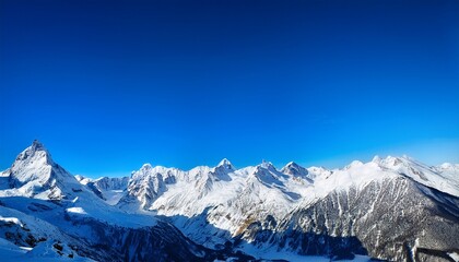 a snowy mountain range under a bright blue sky