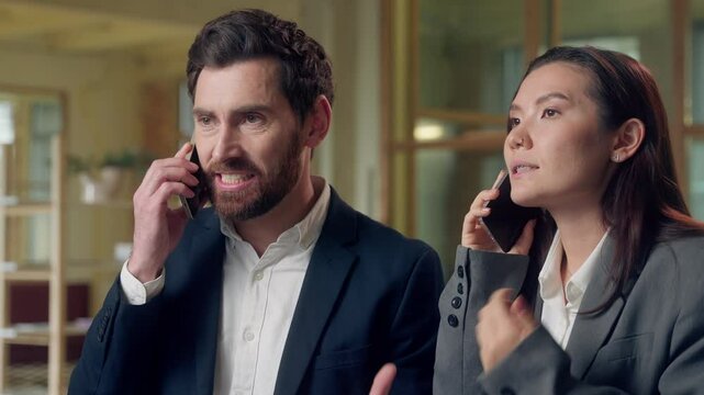 Multiethnic stressed business workers man woman speaking mobile phone calls conflict at office Korean businesswoman talk arguing smartphone Caucasian businessman shouting cellphone problems deal fail