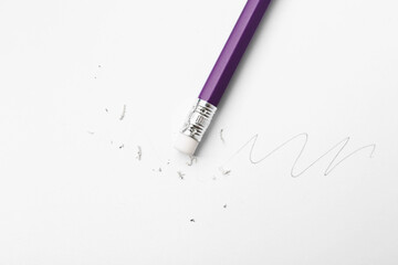 Pencil with eraser, doodle and scraps on white background, top view