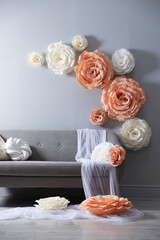 Photo zone with stylish floral decor and sofa in studio