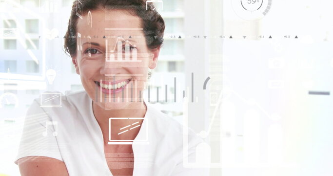 Smiling woman wearing white blouse presenting bar charts line graphs in office, with circular gauge