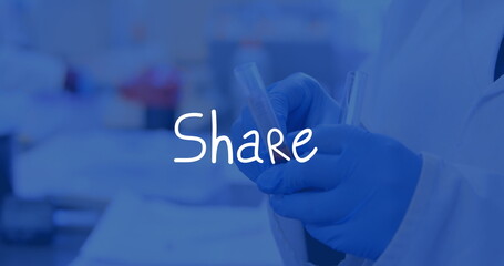 Technician wearing white lab coat and blue gloves holding two clear test tubes at laboratory bench