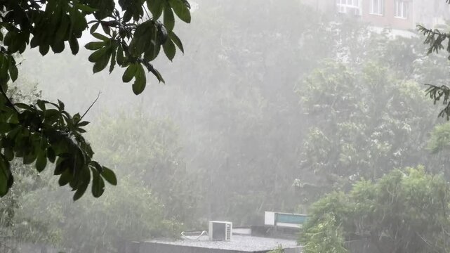 Severe thunderstorm with heavy rain hail and strong wind in city during summer