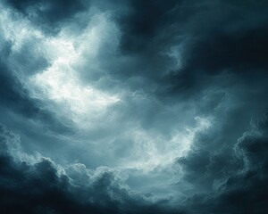 Obraz premium Dramatic swirling dark storm clouds with illuminated bright patches in a turbulent sky