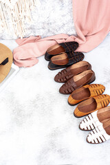 A variety of leather shoes arranged on a fabric background, perfect for leather industry catalog design.