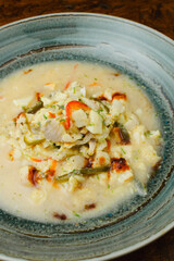 Spicy Aguachile, a traditional Mexican and Latin American raw fish or seafood dish similar to ceviche, marinated in chili and lime juice (leche de tigre), served as a gourmet appetizer in a bowl.