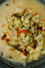 Spicy Aguachile, a traditional Mexican and Latin American raw fish or seafood dish similar to ceviche, marinated in chili and lime juice (leche de tigre), served as a gourmet appetizer in a bowl.