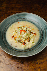 Spicy Aguachile, a traditional Mexican and Latin American raw fish or seafood dish similar to ceviche, marinated in chili and lime juice (leche de tigre), served as a gourmet appetizer in a bowl.