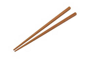Pair of wooden chopsticks lying parallel on a transparent background, ready for use in asian cuisine