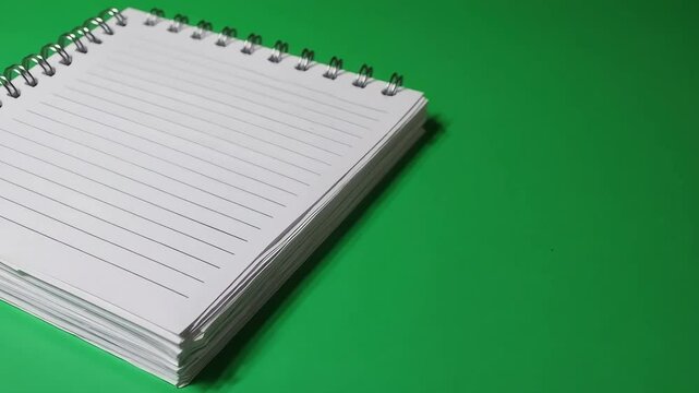 Blank Spiral Notebook on Vibrant Green Background for Creative Uses with ai generated