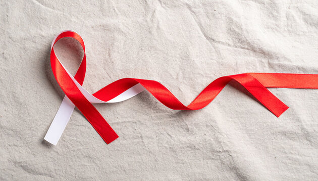 A close-up shot of a red and white ribbon, symbolizing awareness and support for a cause.