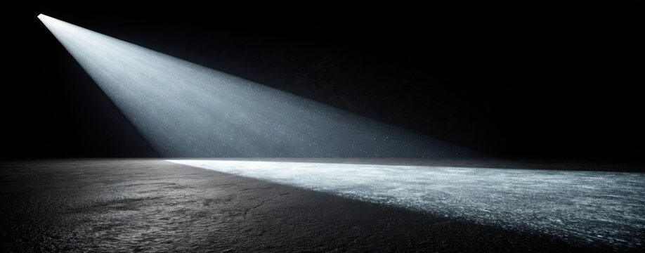 A dramatic spotlight shines on a dark stage illuminating the textured floor with a bright beam of light - Powered by Adobe