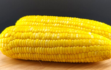 Sweet corn on a plate with a black background