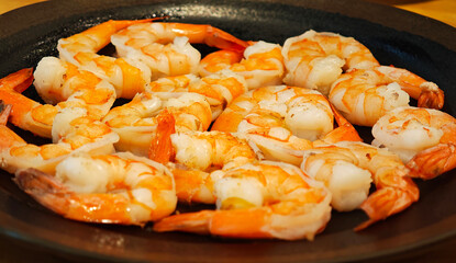 Boiled shrimp on a black plate