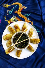 Dumplings gyoza with soy sauce and chopsticks on a plate 