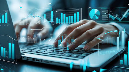 Typing on laptop with data graphs overlayed on screen