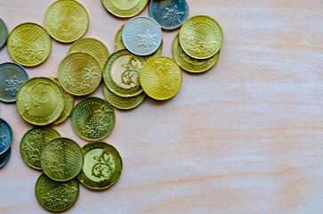 Piled coins on desk surface with customizable space for text or ideas