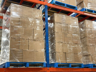 Pallets of boxes of wine stacked in distribution centre ready for shipment.