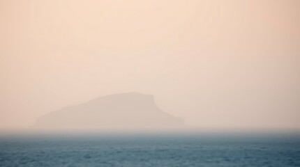 Misty island emerges from watery expanse