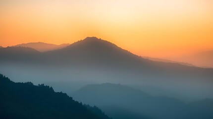 Obraz premium Misty mountains bathed in golden sunlight
