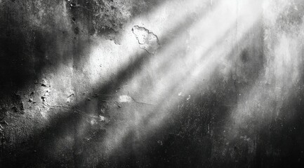A monochromatic close-up captures a textured surface, possibly metallic or stone, dramatically lit by a diagonal beam of light, revealing a variety of  imperfections and wear patterns