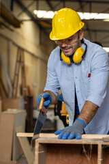 young male carpenter worker hold wooden plank at the carpentry workshop