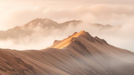 Naklejka premium Mountains shrouded in fog illuminated softly