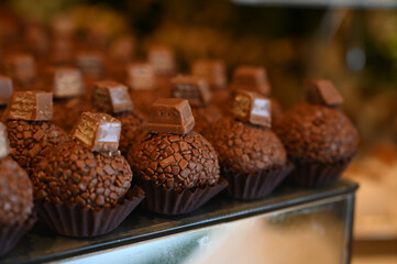 chocolate truffles,truffles,chocolate ball on a wooden tray, condensed milk candy balls, chocolate truffles, brigadeiro, chocolate sprinkles, chocolate candy, condensed milk candy balls, candy balls, 