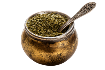Yerba mate in a traditional gourd with a silver spoon.