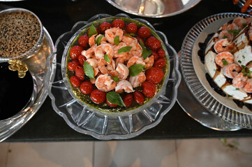 shrimp caprese, shrimp caprese salad with cherry tomatoes and mozzarella, gourmet seafood caprese served in glass bowl, elegant shrimp appetizer with basil

