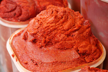 Bright red chili paste displayed at a local market stall
