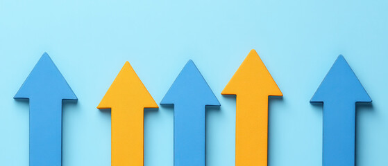 Series of blue and orange arrows pointing upward on light blue background, symbolizing growth and progress