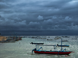 boat on the beach in Bali under a stormey sky
