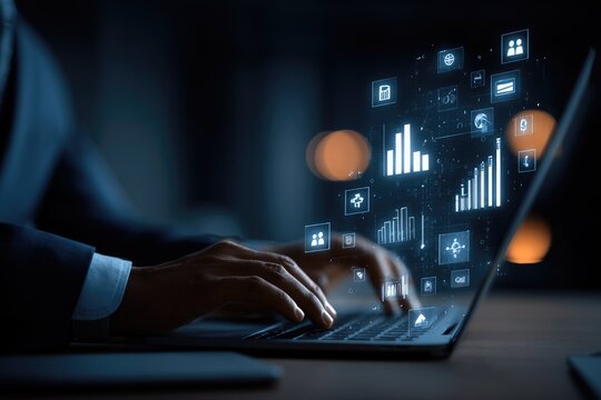 Person working on laptop, glowing data graphics overlay