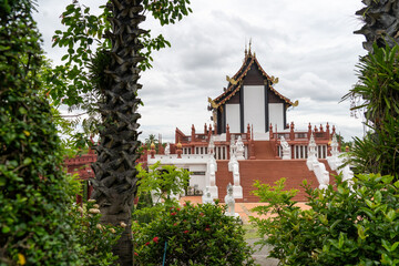 A large building with a white roof and a white wall