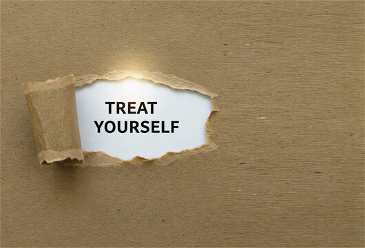 Torn brown paper with "Treat Yourself" text. Personal care must be the top priority.  Time to treat yourself to something nice. Love yourself campaign on social, electronic and print media.
