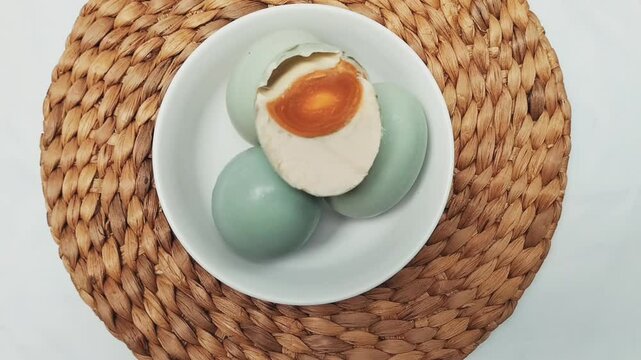 Selective focus. Salted Egg is a traditional dish from Brebes, Central Java, Indonesia. It is made from duck eggs that are salted and then boiled. Footage.
