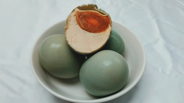 Selective focus. Salted Egg is a traditional dish from Brebes, Central Java, Indonesia. It is made from duck eggs that are salted and then boiled. Footage.