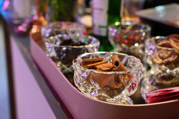 christmas table setting, cocktail bar garnishes, elegant drink station, sophisticated beverage setup, cinnamon in a glass bowl
