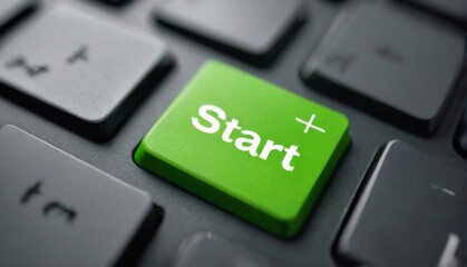 Bright green Start button on a black keyboard in QWERTY layout, positioned in the center and slightly tilted right.