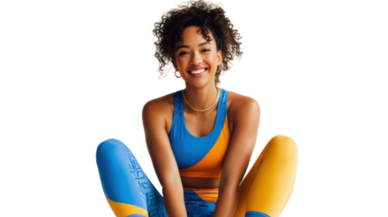 Cheerful young woman in activewear smiles while sitting on the floor, exuding positivity and wellness.