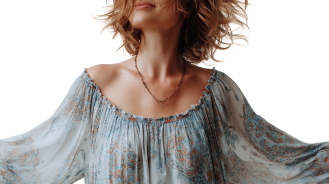 A woman in a flowing dress poses gracefully with her hair blowing in the wind, captured against a white background. - Powered by Adobe