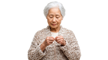 Elderly woman crafting with hands, focused expression, white isolated background.