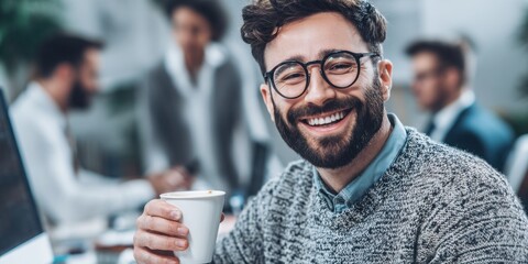 Candid Photos Capturing Realistic Moments Concept. Smiling man with glasses holding coffee mug in modern office during casual business meeting