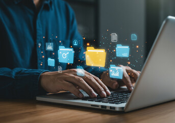 Person typing on a laptop with digital file folders floating