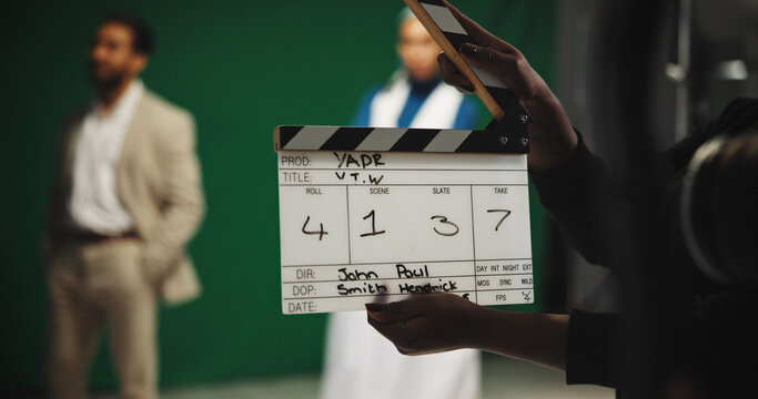 Person, producer and hands with clapperboard on set for take, action or camera roll in production. Closeup, director or assistant with movie slate for film making, videography edit or start scene