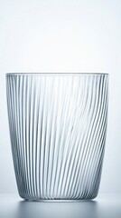 Empty glass bowl, ribbed, swirling design.